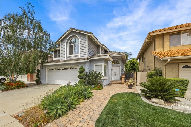 14252 Parkside Ct, Chino Hills, CA 91709 - traditional-style house with stucco siding, a garage, concrete driveway, a tile roof, and a gate