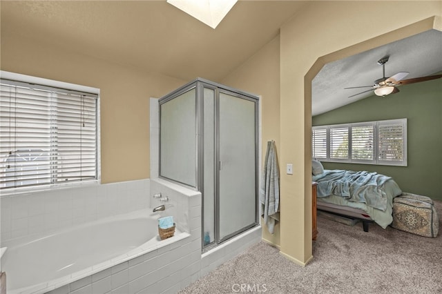 14252 Parkside Ct, Chino Hills, CA 91709 - ensuite bathroom featuring vaulted ceiling, a bath, a stall shower, a skylight, and a ceiling fan