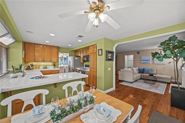 14252 Parkside Ct, Chino Hills, CA 91709 - dining room with dark wood finished floors, plenty of natural light, recessed lighting, a ceiling fan, and a chandelier