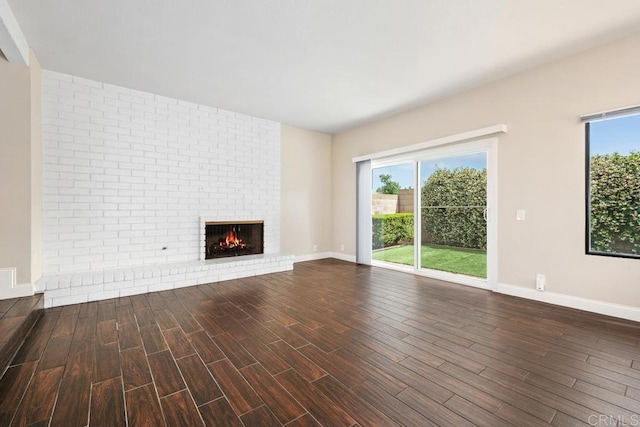6 Cape Cod, Irvine, CA 92620 - unfurnished living room featuring dark wood-type flooring, a fireplace, and baseboards