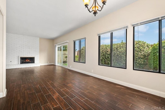 6 Cape Cod, Irvine, CA 92620 - unfurnished living room with a chandelier, wood finished floors, and a fireplace
