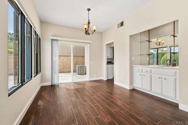 6 Cape Cod, Irvine, CA 92620 - unfurnished dining area with a chandelier and dark wood finished floors