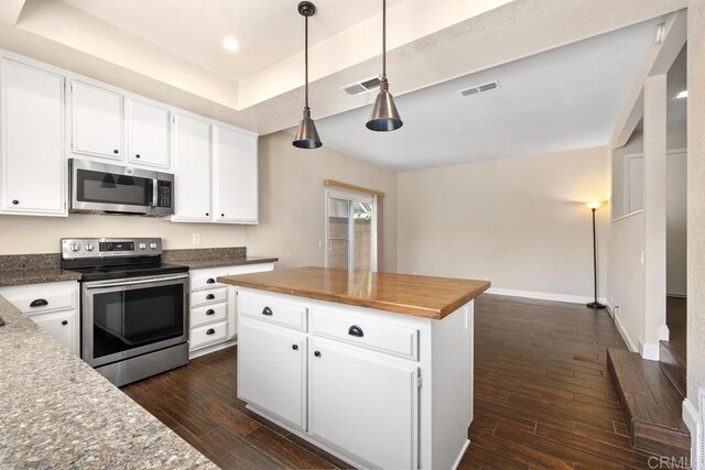 6 Cape Cod, Irvine, CA 92620 - kitchen featuring appliances with stainless steel finishes, dark wood finished floors, butcher block counters, white cabinetry, and recessed lighting