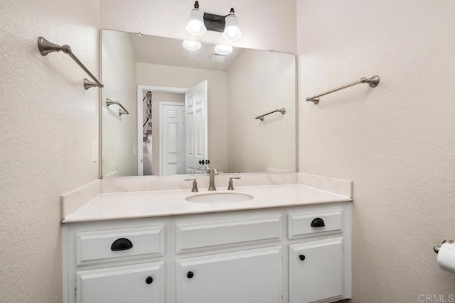 6 Cape Cod, Irvine, CA 92620 - bathroom with vanity and a textured wall