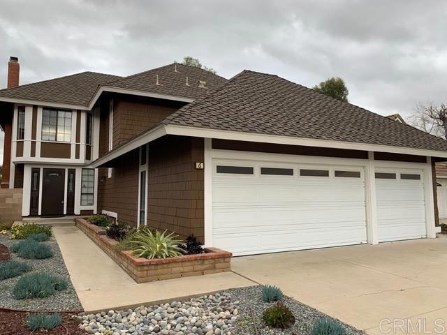 6 Cape Cod, Irvine, CA 92620 - view of front facade featuring an attached garage, a shingled roof, driveway, and a chimney