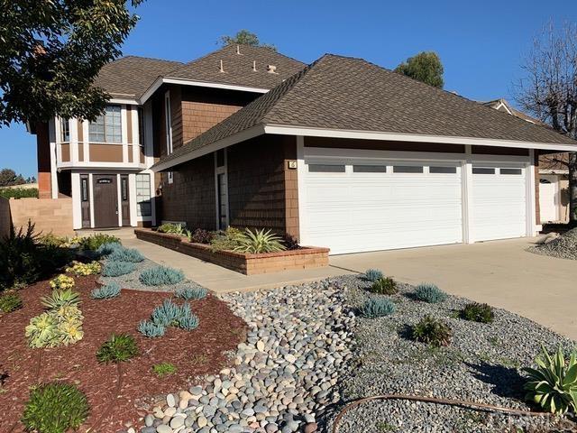 6 Cape Cod, Irvine, CA 92620 - view of front of house featuring an attached garage, driveway, and a shingled roof