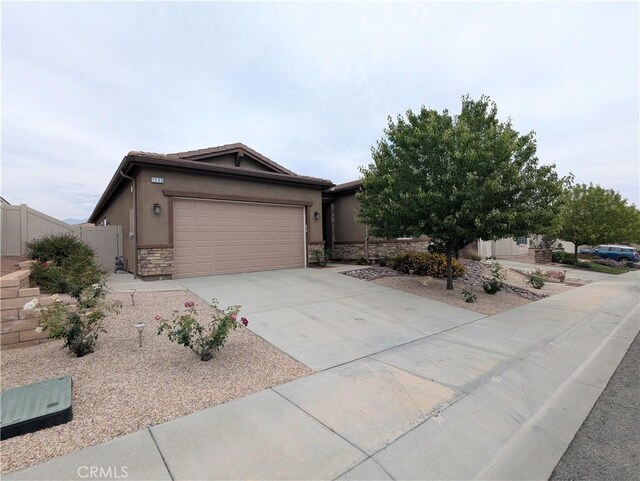 1582 Timberline, Beaumont, CA 92223 - view of front of home with driveway, an attached garage, stucco siding, and stone siding