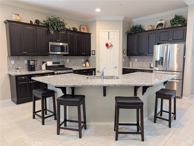 1582 Timberline, Beaumont, CA 92223 - kitchen with stainless steel appliances, decorative backsplash, a breakfast bar, light stone countertops, and ornamental molding