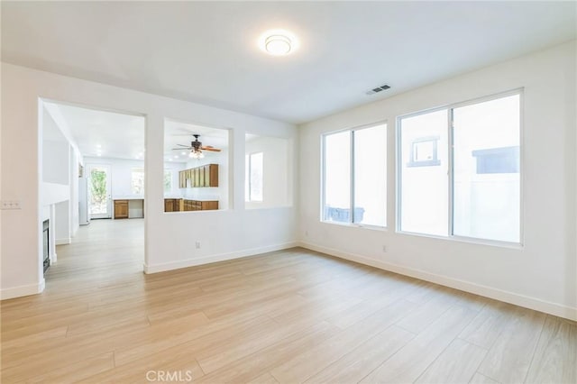 1172 Cedar Hollow Rd, Beaumont, CA 92223 - unfurnished room featuring healthy amount of natural light, light wood-type flooring, and a ceiling fan