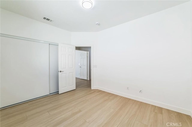 1172 Cedar Hollow Rd, Beaumont, CA 92223 - unfurnished bedroom featuring light wood-style floors and a closet