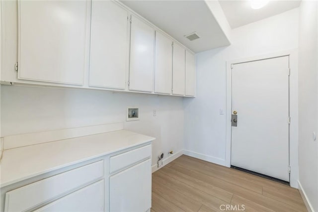1172 Cedar Hollow Rd, Beaumont, CA 92223 - laundry room with cabinet space, hookup for a washing machine, and light wood-style flooring
