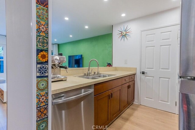 18350 Hatteras St Unit 169, Tarzana, CA 91356 - kitchen with dishwasher, a sink, light wood-style floors, light countertops, and recessed lighting