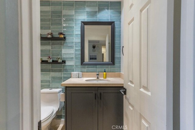 18350 Hatteras St Unit 169, Tarzana, CA 91356 - bathroom with tile walls, vanity, toilet, and tasteful backsplash