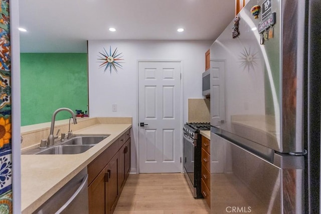 18350 Hatteras St Unit 169, Tarzana, CA 91356 - kitchen featuring stainless steel appliances, a sink, light wood-style floors, light countertops, and recessed lighting