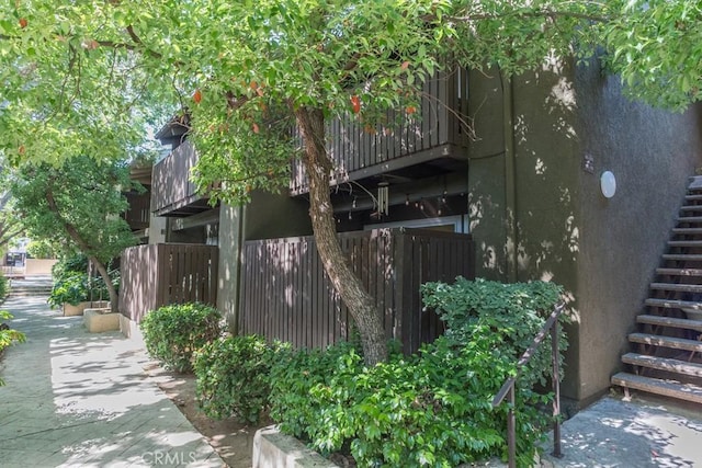 18350 Hatteras St Unit 169, Tarzana, CA 91356 - view of side of home featuring stairs and stucco siding