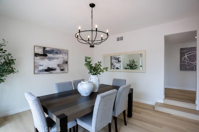 22282 Canones Cir, Saugus, CA 91350 - dining area featuring a chandelier, light wood-style floors, and baseboards