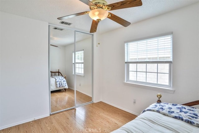 10249 Candlewood St, Rancho Cucamonga, CA 91730 - bedroom featuring light wood-style floors, a closet, baseboards, a textured ceiling, and a ceiling fan