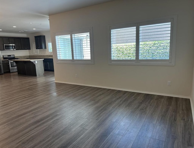 253 Oberland Way, Fallbrook, CA 92028 - unfurnished living room with dark wood-style flooring, baseboards, and recessed lighting