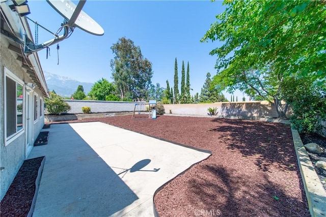 6597 Kinlock Ave, Rancho Cucamonga, CA 91737 - fenced backyard with a patio and a mountain view