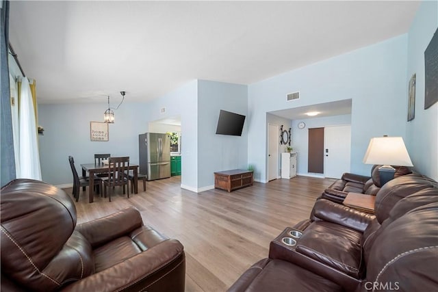 6597 Kinlock Ave, Rancho Cucamonga, CA 91737 - living room featuring light wood-type flooring, baseboards, and a chandelier