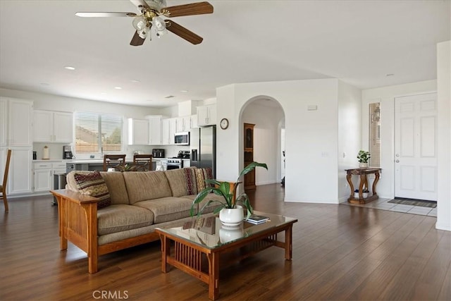 1467 Hunter Moon Way, Beaumont, CA 92223 - living area with arched walkways, a ceiling fan, dark wood-style floors, and recessed lighting