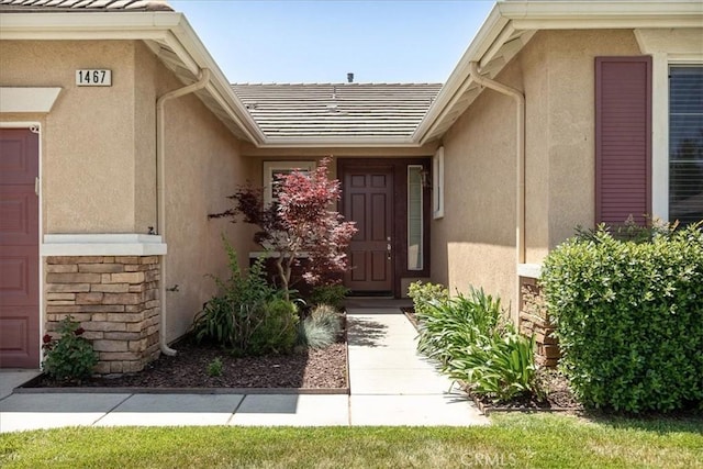 1467 Hunter Moon Way, Beaumont, CA 92223 - property entrance featuring stucco siding, a tiled roof, and stone siding