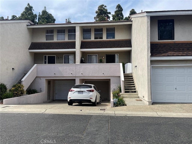 404 Brighton Spgs, Costa Mesa, CA 92627 - view of property with stairs, an attached garage, and driveway