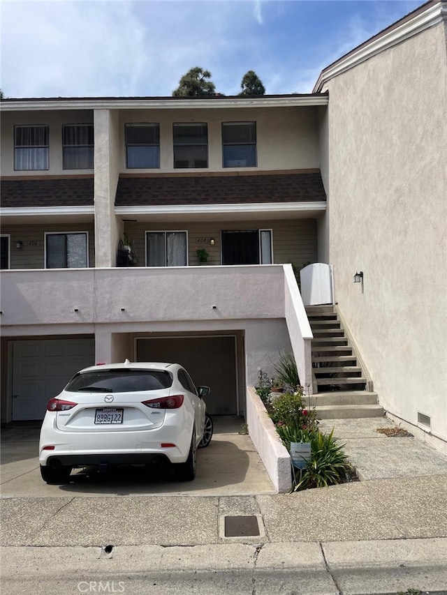 404 Brighton Spgs, Costa Mesa, CA 92627 - view of front of house with a garage, concrete driveway, stucco siding, and stairs