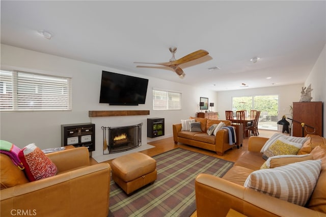 6017 Carnegie St, San Diego, CA 92122 - living area featuring ceiling fan, a lit fireplace, and light wood finished floors