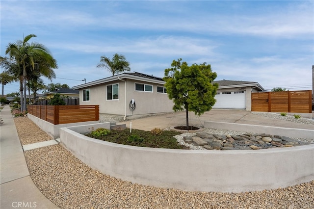 6017 Carnegie St, San Diego, CA 92122 - ranch-style house featuring roof mounted solar panels, driveway, stucco siding, and a garage