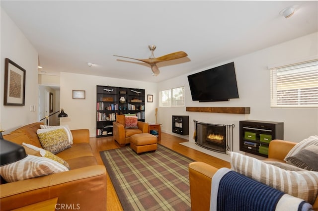 6017 Carnegie St, San Diego, CA 92122 - living room featuring a fireplace with flush hearth, wood finished floors, and ceiling fan