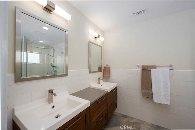 6017 Carnegie St, San Diego, CA 92122 - bathroom with double vanity, tile walls, a stall shower, and wainscoting