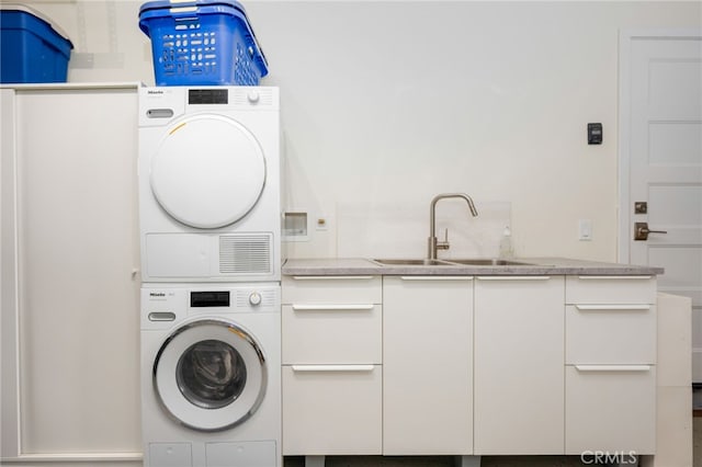 6017 Carnegie St, San Diego, CA 92122 - washroom with stacked washer and clothes dryer and cabinet space