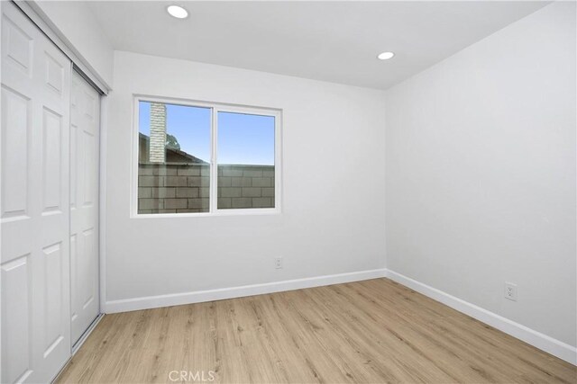 1348 Sandia St, Corona, CA 92882 - unfurnished bedroom featuring light wood-style flooring, baseboards, a closet, and recessed lighting