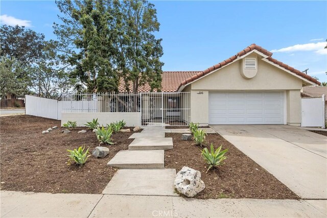 1348 Sandia St, Corona, CA 92882 - view of front of home with stucco siding, driveway, a tile roof, and an attached garage