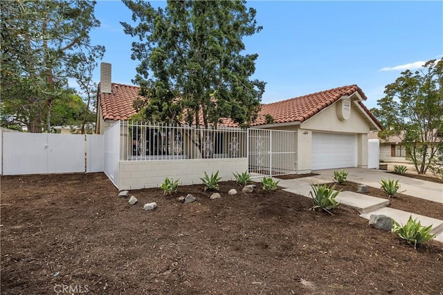 1348 Sandia St, Corona, CA 92882 - view of front of house with a tiled roof, a gate, concrete driveway, and stucco siding