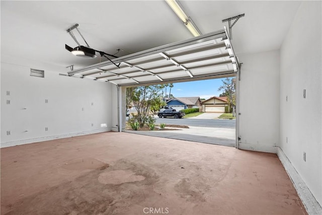1348 Sandia St, Corona, CA 92882 - garage featuring a garage door opener and baseboards