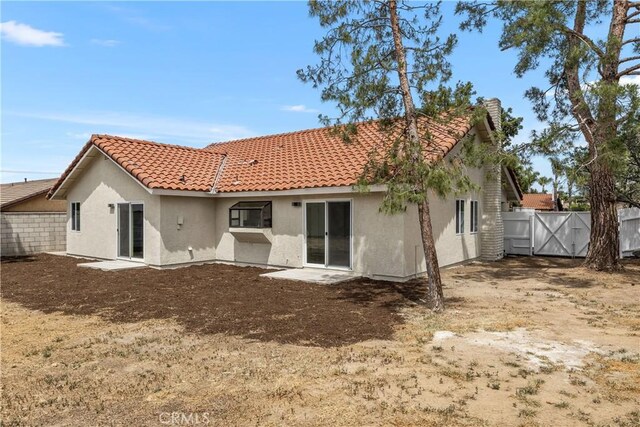 1348 Sandia St, Corona, CA 92882 - rear view of property with stucco siding, a tiled roof, and a gate