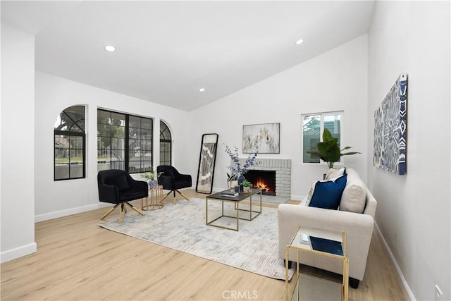1348 Sandia St, Corona, CA 92882 - living area featuring wood finished floors, baseboards, a brick fireplace, recessed lighting, and lofted ceiling