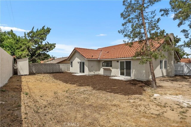 1348 Sandia St, Corona, CA 92882 - rear view of property with a tile roof, stucco siding, and a fenced backyard