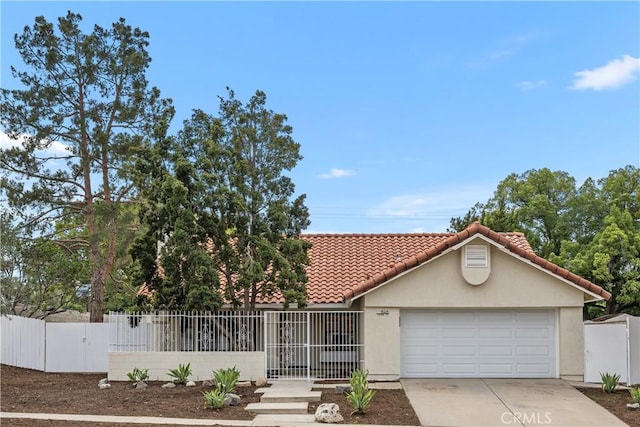 1348 Sandia St, Corona, CA 92882 - view of front of property with driveway, stucco siding, a tile roof, an attached garage, and a gate
