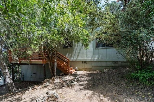 645 Worcester Dr, Cambria, CA 93428 - view of side of home featuring stairway and crawl space