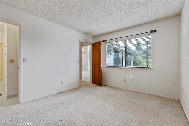 645 Worcester Dr, Cambria, CA 93428 - unfurnished room featuring carpet, a textured ceiling, and baseboards
