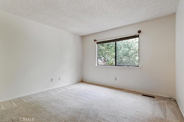 645 Worcester Dr, Cambria, CA 93428 - carpeted empty room featuring a textured ceiling and baseboards