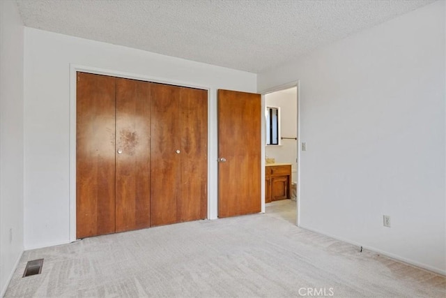 645 Worcester Dr, Cambria, CA 93428 - unfurnished bedroom with carpet flooring, a closet, and a textured ceiling