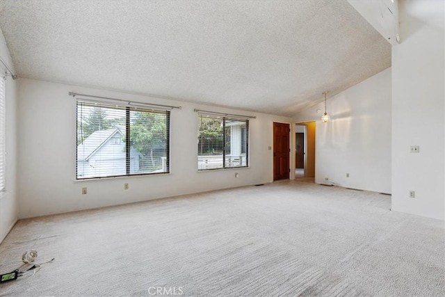 645 Worcester Dr, Cambria, CA 93428 - spare room with a textured ceiling, light colored carpet, and vaulted ceiling