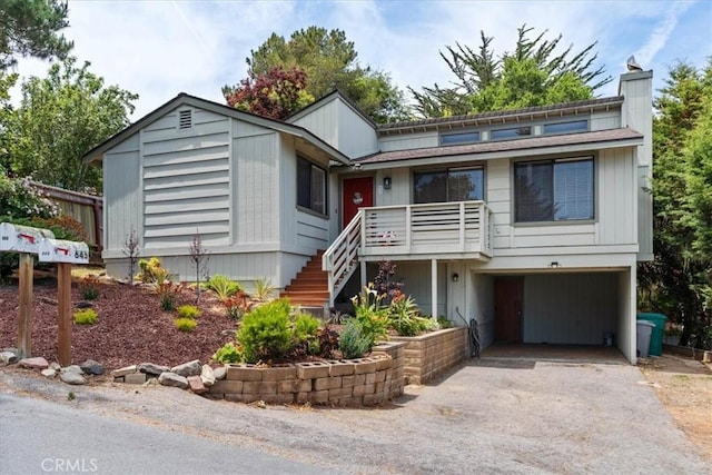 645 Worcester Dr, Cambria, CA 93428 - view of front of property featuring asphalt driveway, an attached garage, a chimney, and stairs