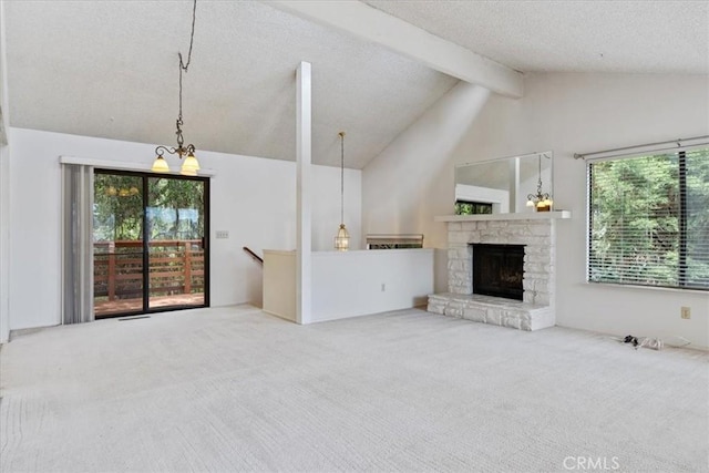 645 Worcester Dr, Cambria, CA 93428 - unfurnished living room featuring carpet flooring, plenty of natural light, a stone fireplace, and a textured ceiling