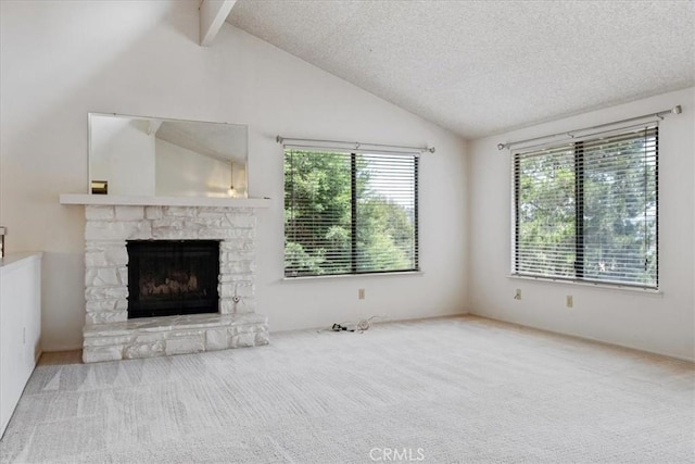 645 Worcester Dr, Cambria, CA 93428 - unfurnished living room with a stone fireplace, carpet, and a textured ceiling