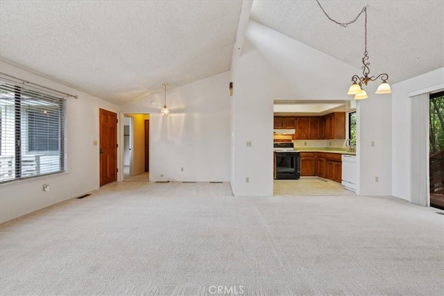 645 Worcester Dr, Cambria, CA 93428 - unfurnished living room with a textured ceiling, a chandelier, light colored carpet, a sink, and high vaulted ceiling